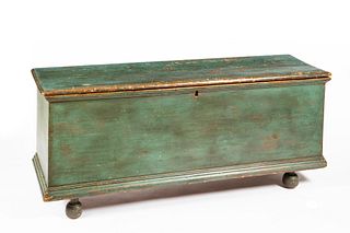 Early American green/blue blanket chest with bun feet and dovetailed construction .